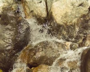 Flowing and bubbling water over rocks filmed in slow motion with a Fastec TS5 high speed camera