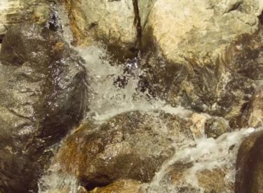 Flowing and bubbling water over rocks filmed in slow motion with a Fastec TS5 high speed camera