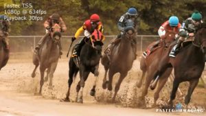 Racing horses running a race on dirt track filmed in slow motion with a Fastec TS5 high speed camera